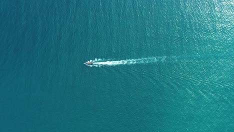 Aerial-view-of-Long-Tail-Boats-floating-on-crystal-water-along-the-sand-beach-in-Thailand