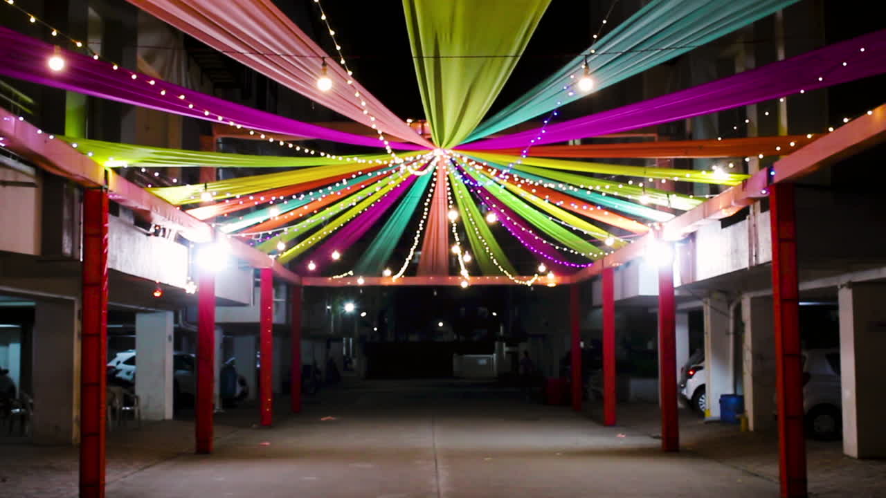 Beautiful Navratri decoration in society with colorful drapes and festive lights at night. Ideal for Indian festival, garba, dandiya, and cultural celebration themes