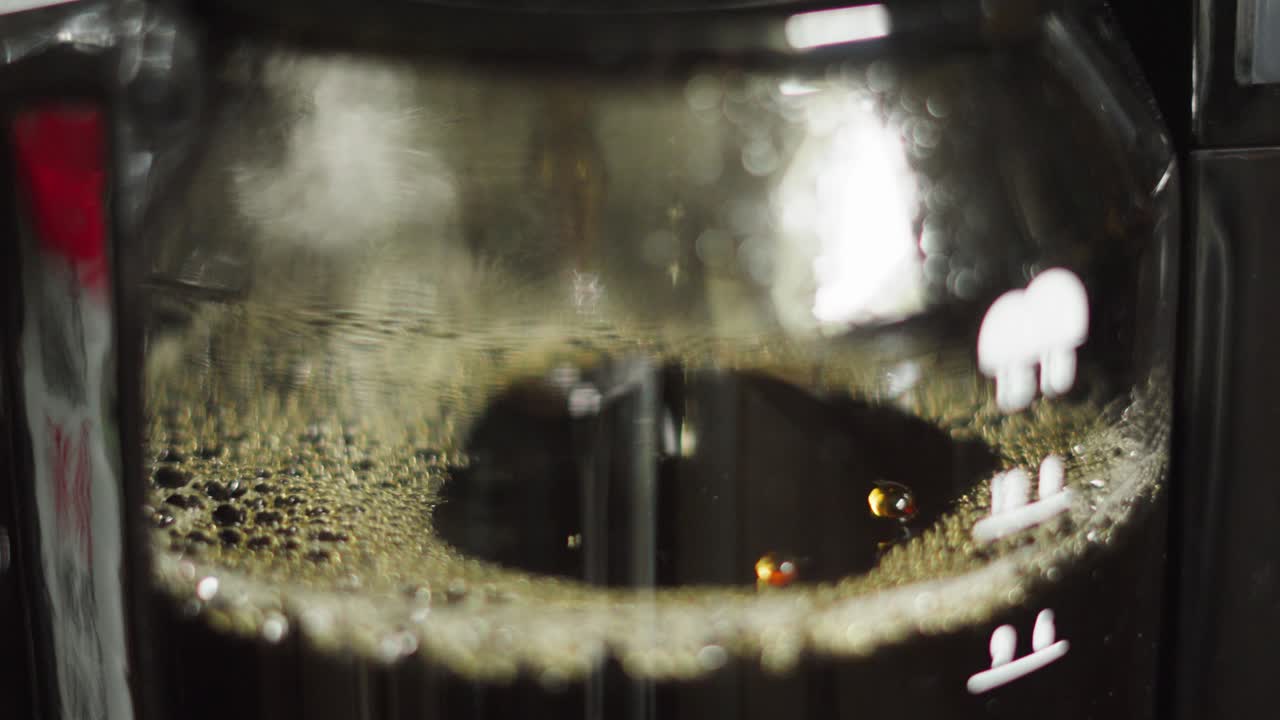 Side View of Coffee Dripping into Jug in Morning as Hot Water Passes Through Ground Beans Filter for Warm Morning Drink. Served at Home, Diners, Cafes.