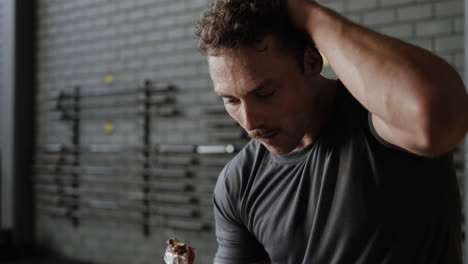 man resting and eating post-workout