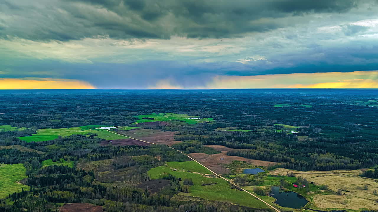 Drone timelapse of dark, rain clouds moving over the countryside, stormy evening