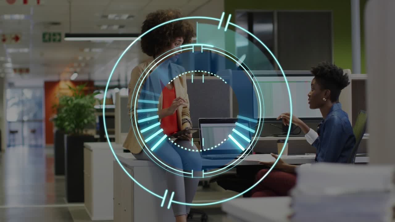 Woman presenting tube, peer pointing to screen while animated HUD pulsing around office monitor
