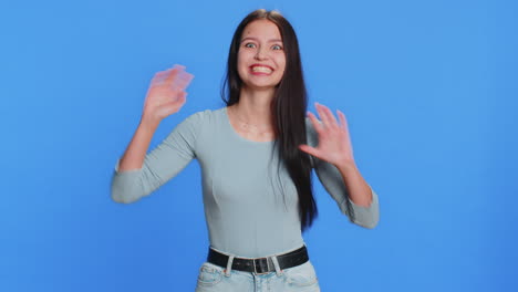 funny comical woman making silly facial expressions and grimacing fooling around showing tongue