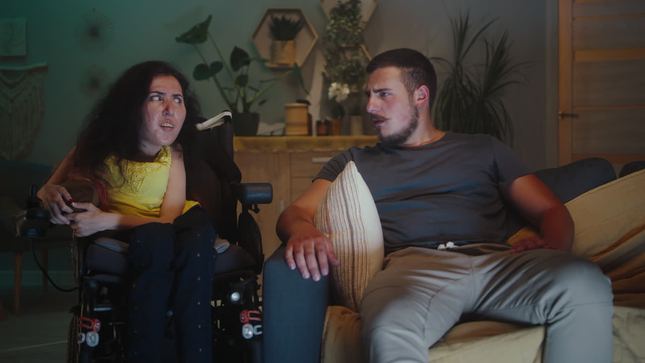 Woman with Disability and Man Watching TV