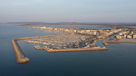 Aerial-back-traveling-sunrise-over-Palavas-les-Flots-leisure-port-seaside-resort