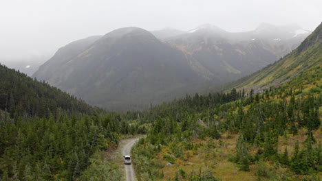 pick up truck driving through the mountain with scenic view in british colombia, canada