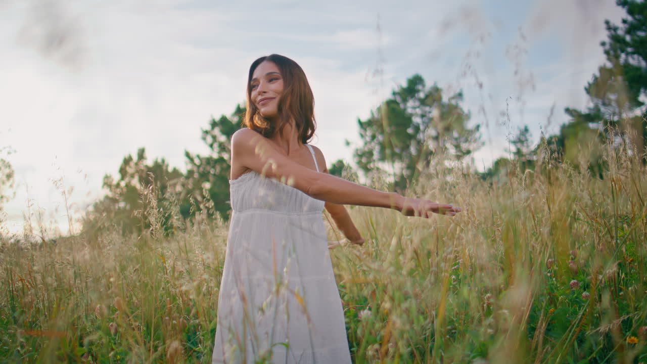 Romantic lady stepping meadow enjoying summer nature closeup. Woman walking