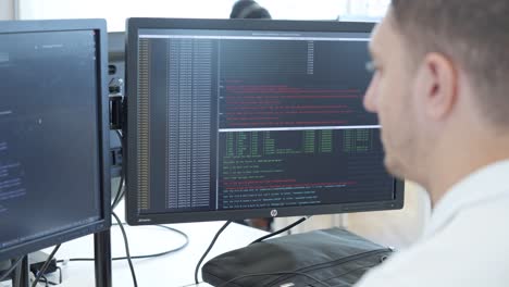 Programmer Working on Two Monitors