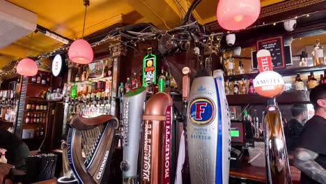 bartender serving drinks in lively london pub