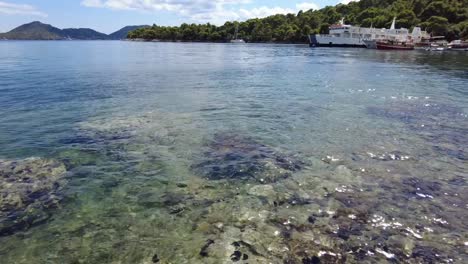 Crystal-clear-waters-revealing-rocky-seabed-on-a-sunny-day-at-Elafiti-Islands,-Croatia