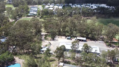 drone descending over a residential suburb and a large storage shed in australia