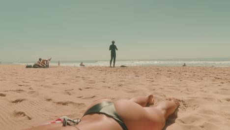 Beach scene with people enjoying the sun and surfing