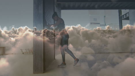 animation of clouds over african american woman stretching