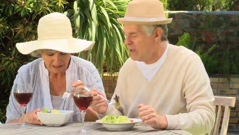 Mature-couple-having-lunch-in-the-garden