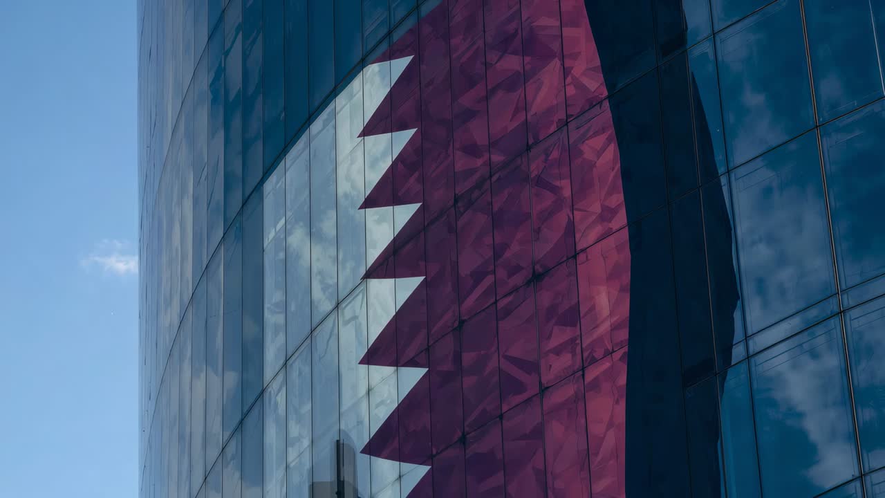 Panning camera showing curved glass tower facade in city, revealing maroon-white serrated motif