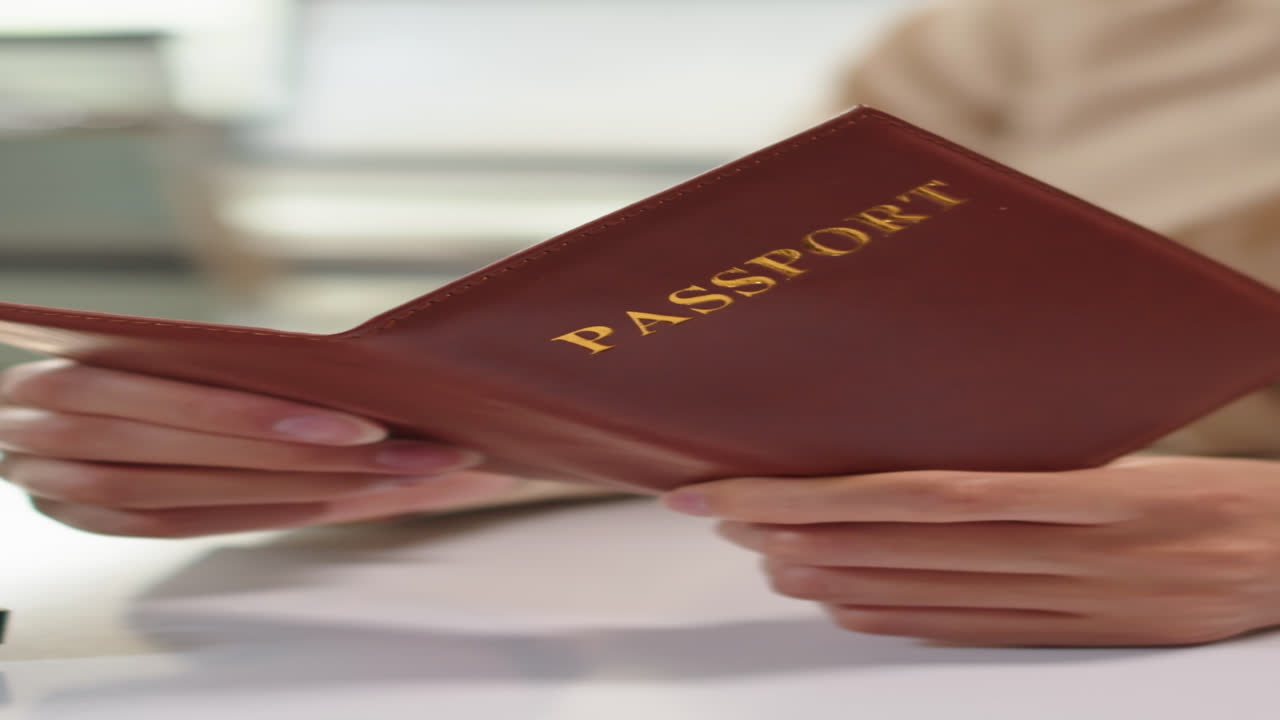 Unrecognizable Manager Checking Passport of Client