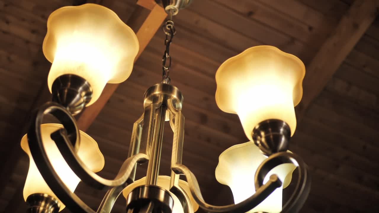 A Classic Vintage Multi-bulb Chandelier Hanging On The Ceiling. Low Angle Shot