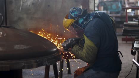 worker polishing in metal industry