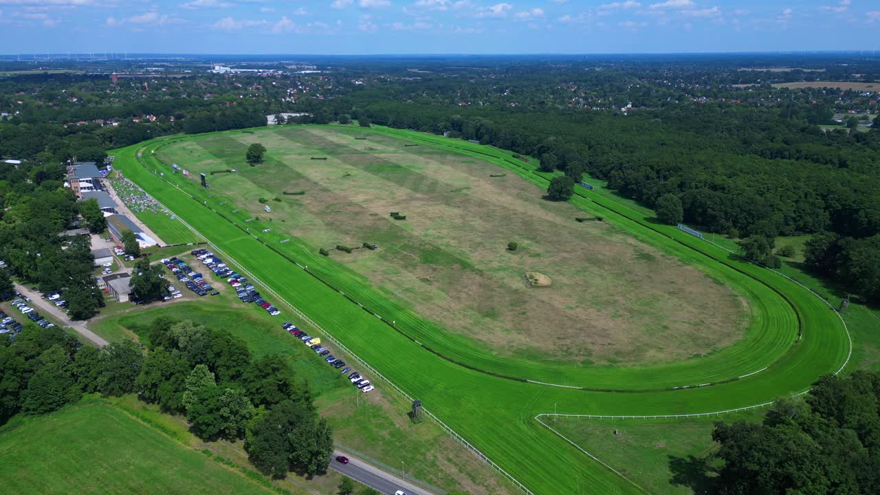 Horse gallop racecourse near a forest in Germany, parking lot visible. Nice aerial view flight panorama overview drone
