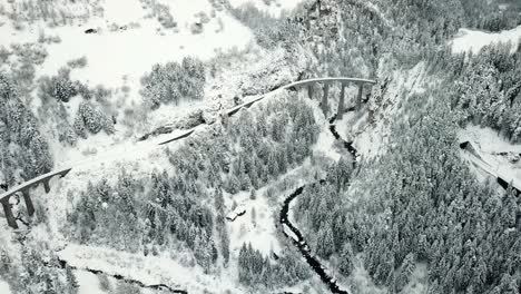 Aerial View of a Snow-Covered Viaduct in the Mountains