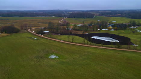 Drone-parallax-above-wintry-calm-village,-serene-atmosphere-in-the-countryside