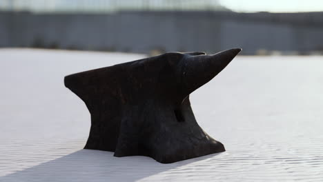 old anvil on a sandy beach