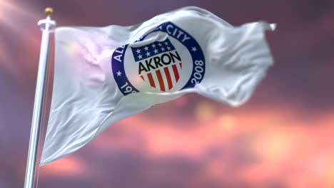 flag of akron city at sunset, ohio, united states of america - loop