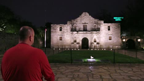 the alamo at night in san antonio, texas with gimbal video following man walking forward