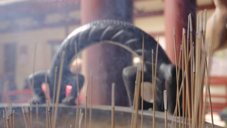 Close-up-shot-of-incense-burning-outside-a-temple-in-Singapore