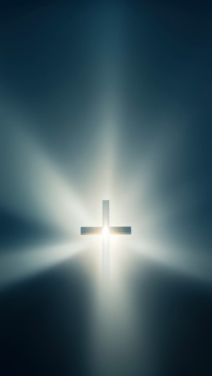 A cross illuminated by radiant light, captured from a low angle. The ethereal glow creates a serene