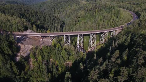 car crossing a bridge over rivers and forests