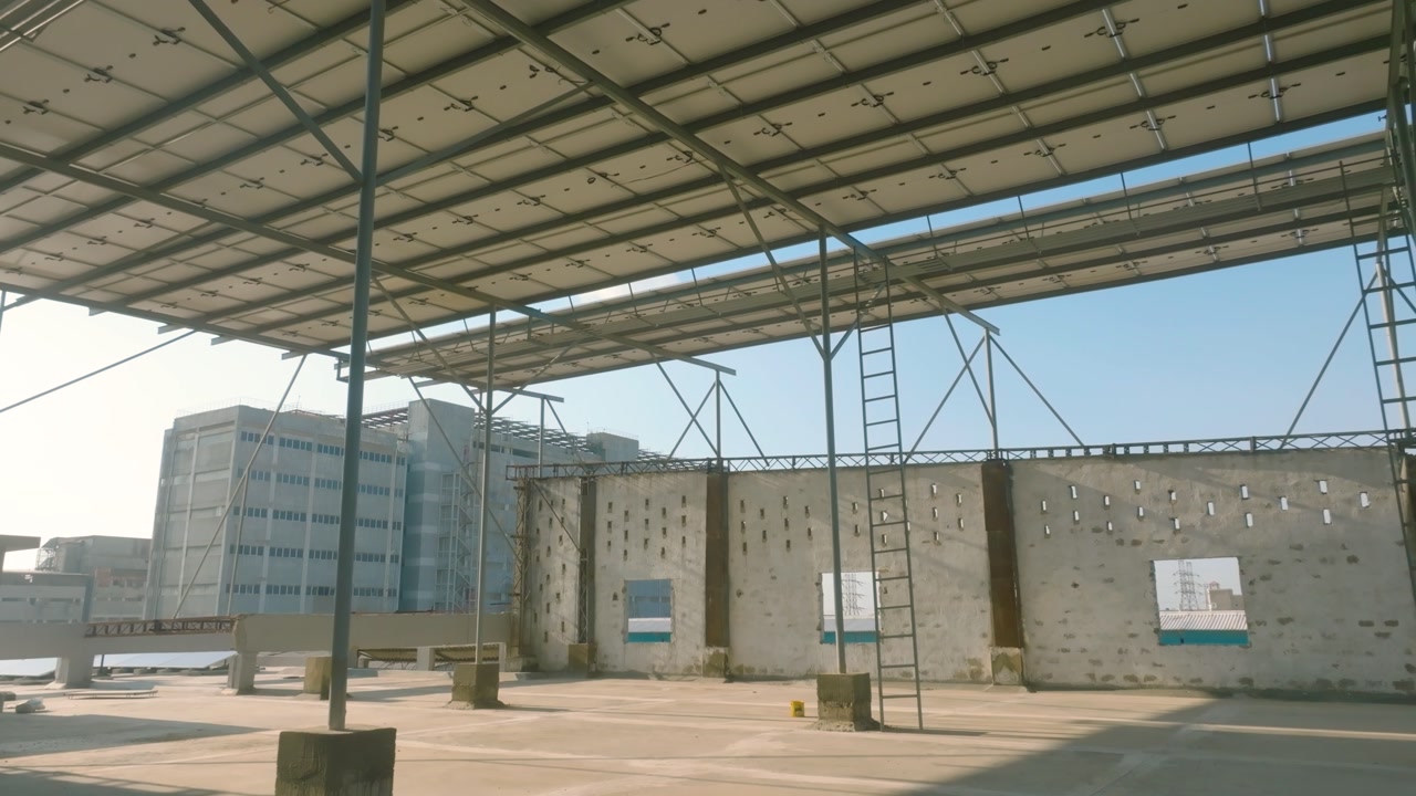 Solar panels covering a factory rooftop in Karachi, generating sustainable energy