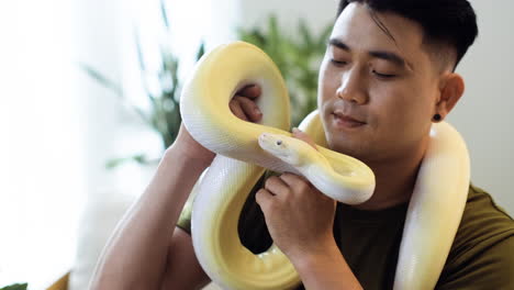 man with snake indoors