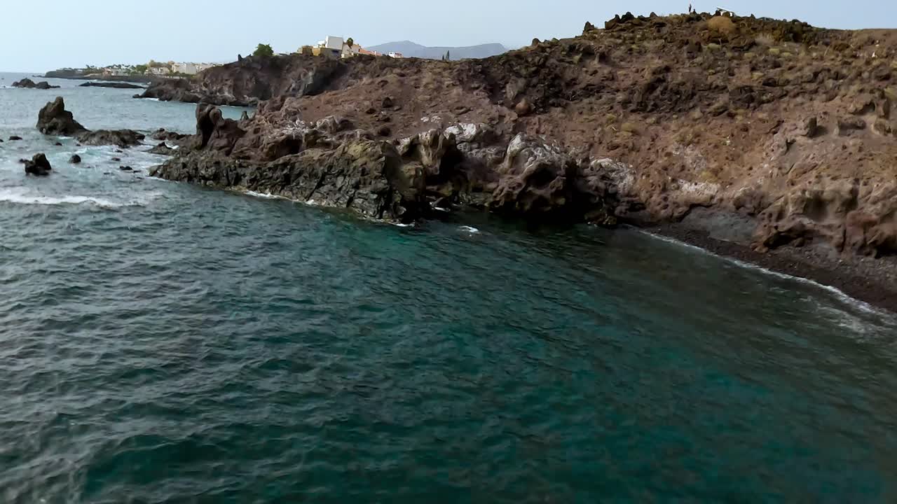 Wild volcanic rock beaches of Tenerife with ocean waves and rugged cliffs