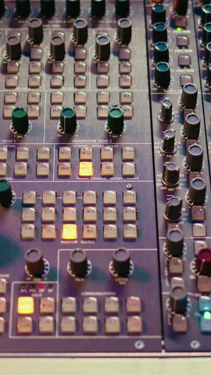 Close-up of an Audio Mixing Console with Blinking Lights