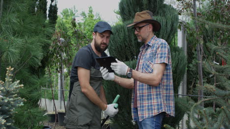 gardeners consulting on plants using a tablet