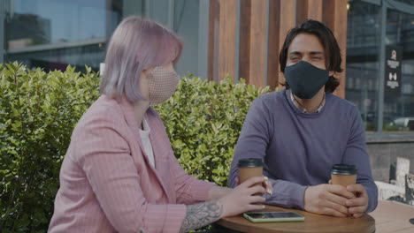 couple enjoying coffee outdoors during pandemic