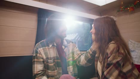 Happy-brunette-guy-in-a-green-checkered-shirt-strokes-his-brunette-girlfriend-in-a-checkered-shirt-during-his-vacation-in-a-trailer-outside-the-city-during-a-picnic-at-a-camp-in-the-summer