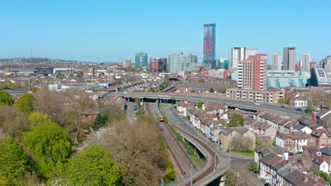 drone shot towards central croydon national rail train passing through