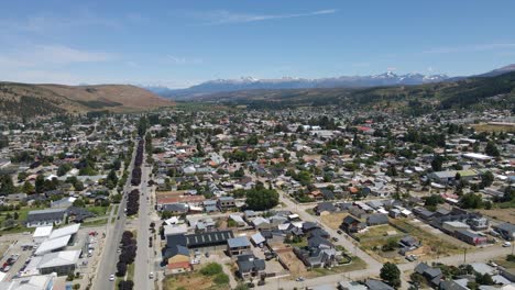 Pan-right-rising-over-Esquel-valley-surrounded-by-Andean-mountains,-Patagonia-Argentina