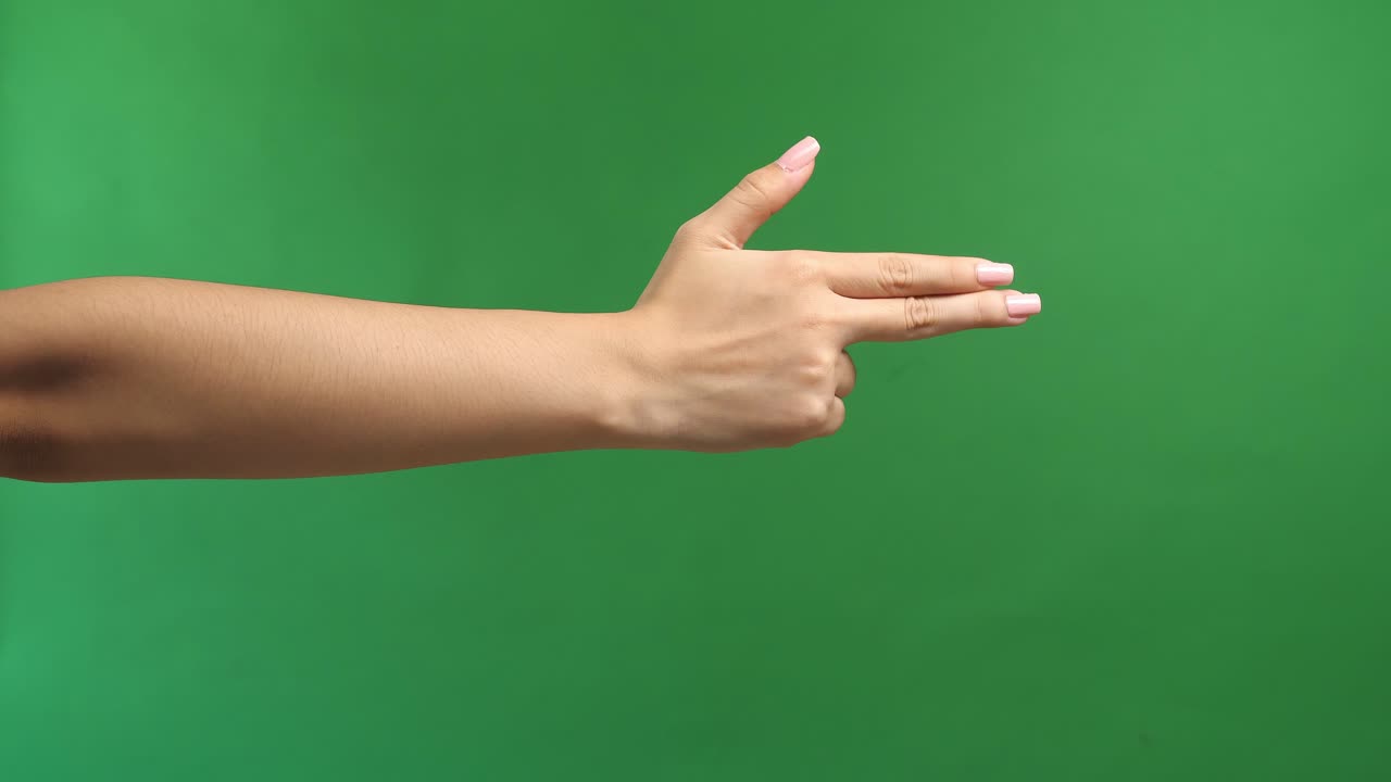 Woman'S Hand Making Shooting Gun, Gesture. Hand Pistol Gesture On Isolated On Green Screen Background. Woman Hand Pointing With Two Fingers