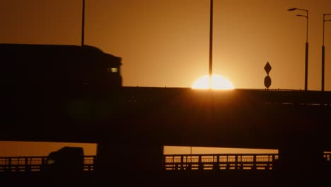 movement of commercial vehicle on road bridge at sunset. cargo transportation, logistics, delivery