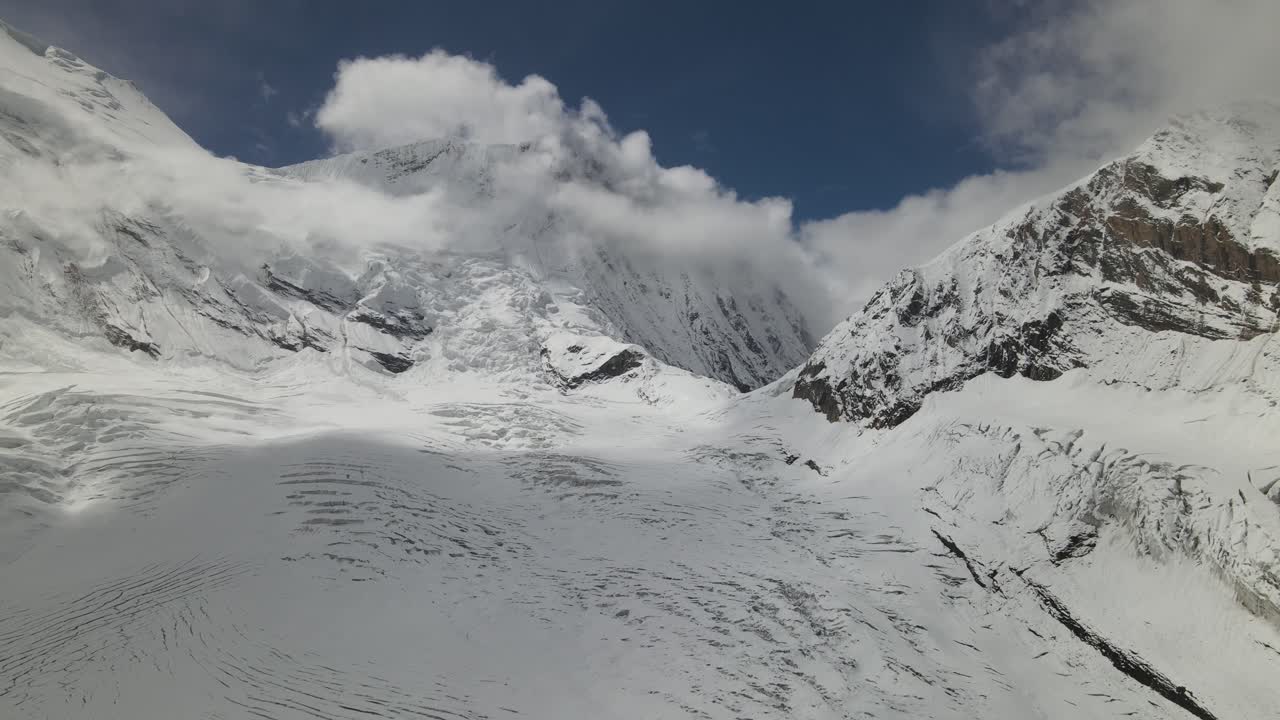 A breathtaking drone view of Manaslu Mountain, rising 8,163 meters in the Nepal Himalaya. The footage captures its towering peaks, dramatic ridges, and pristine high-altitude landscape