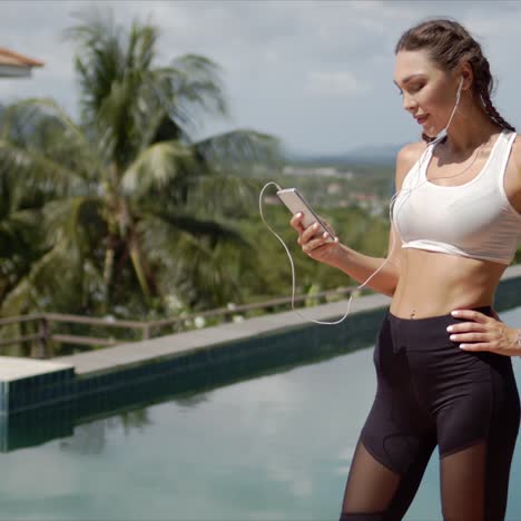 Confident-athlete-using-smartphone-on-poolside