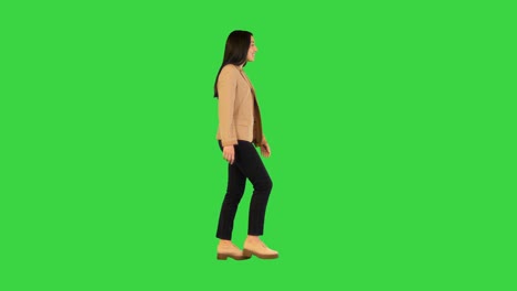 indian girl walking and smiling on a green screen, chroma key