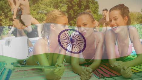 indian flag animation over friends relaxing on beach towels outdoors