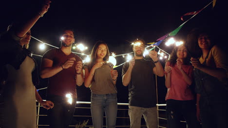 friends celebrate with sparklers at