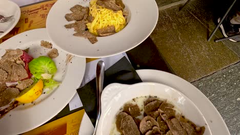 agnolotti and truffle dishes served at a table