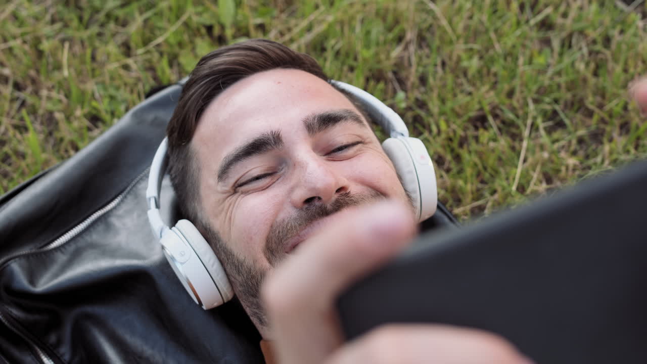 Man Videocalling Lying on Ground