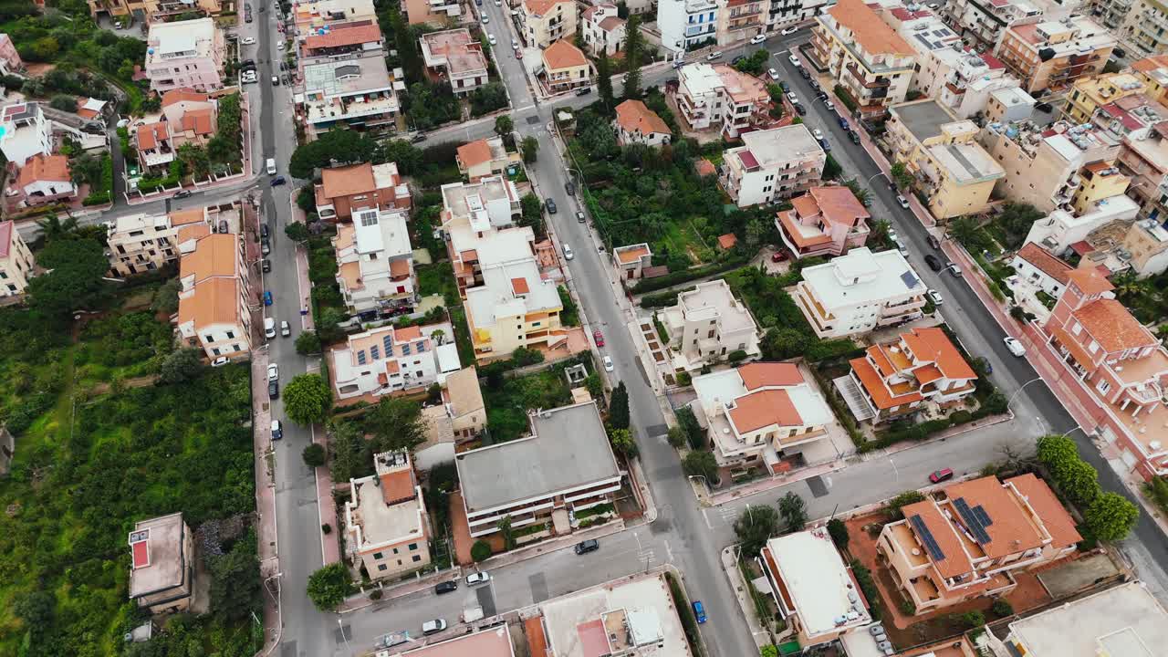 Drone flies over Porticello’s residential streets, showing tightly packed houses, urban infrastructure, and green zones in a southern Italian neighborhood Palermo